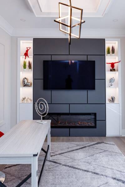 open-concept-living-room-design-ideas modern tv unit with custom fire place and lightened shelves
